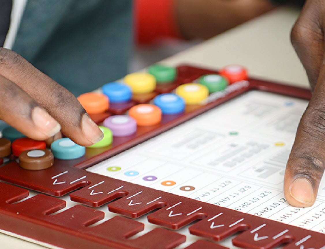 LOGICO MAXIMO feature: Drives Self-Motivated Strategic Learning, showing a close-up of hands moving the buttons on the board.