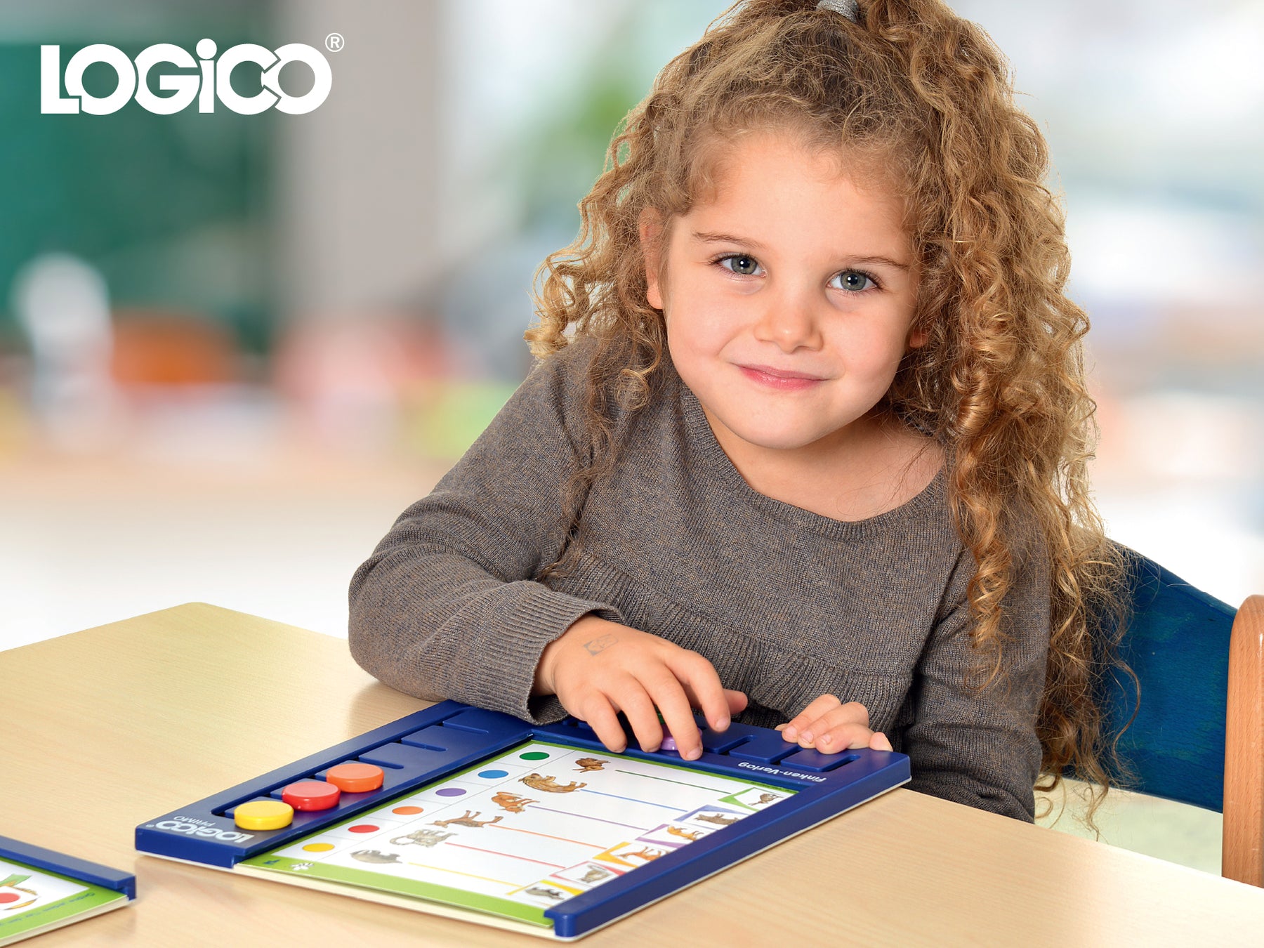 A young girl using the LOGICO RONDO system for ages 2-5.