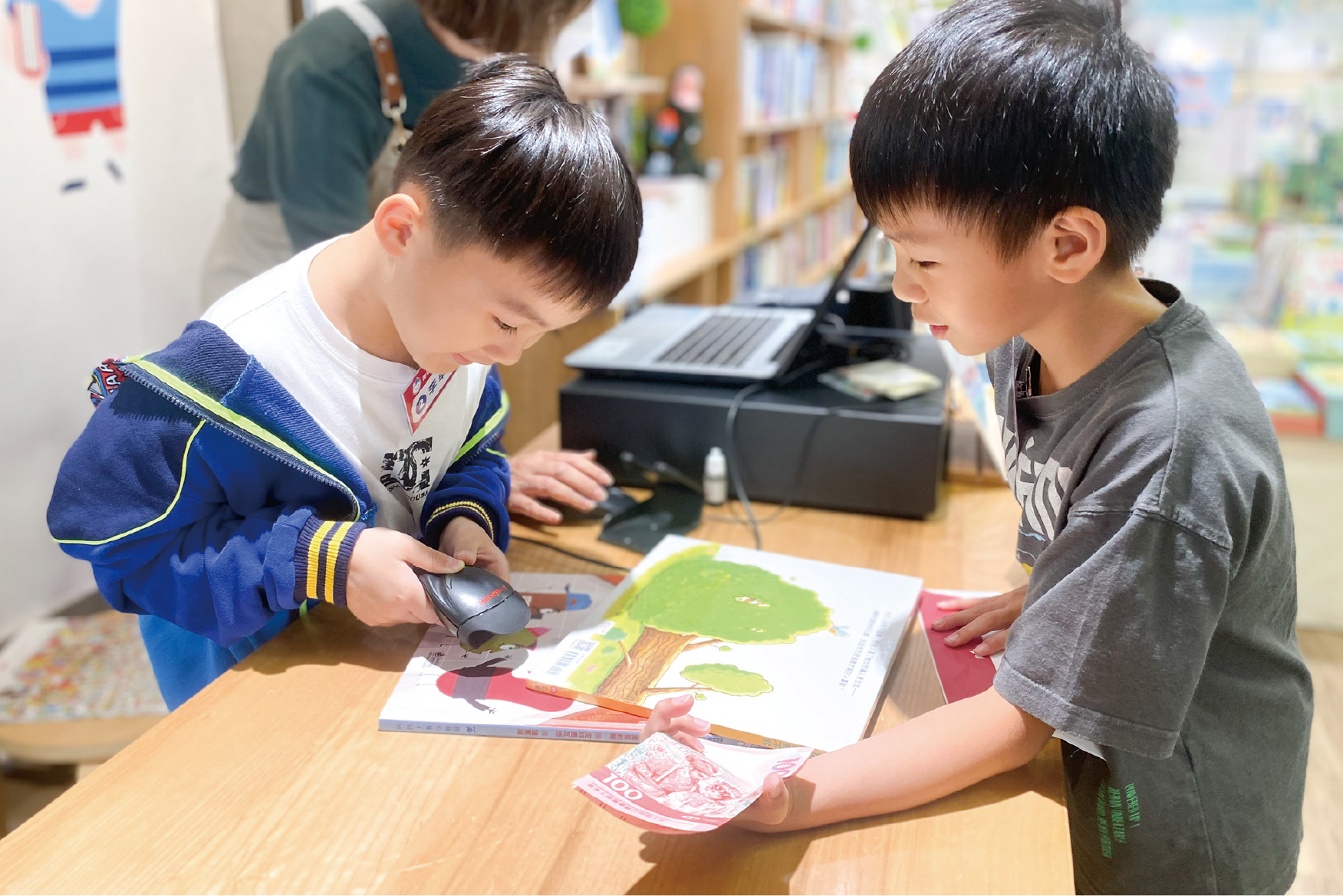 學生正在參與主題閱讀活動，體驗小小店長的角色，掃描圖書條碼。